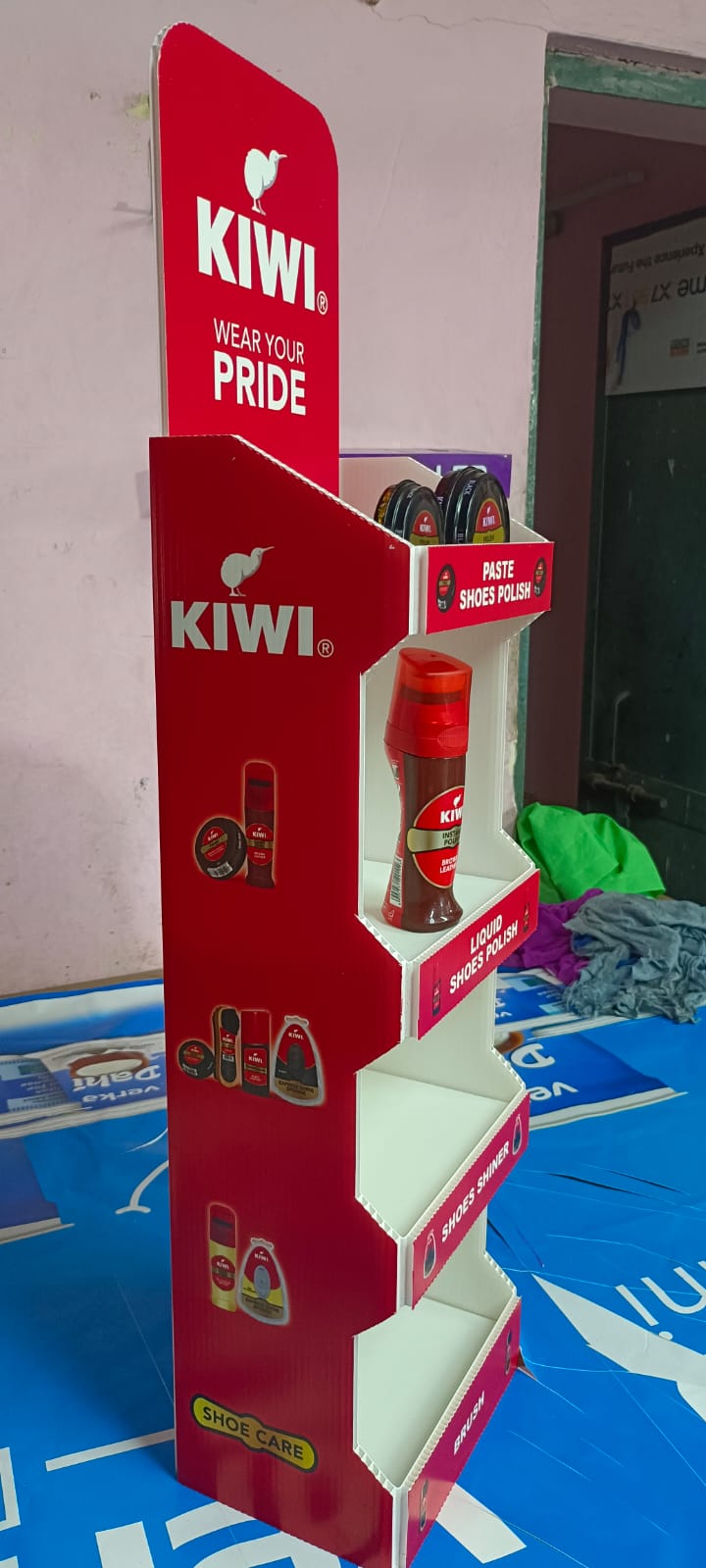 Kiwi FSU: Red tiered floor display rack for shoe-care products - made by Beyond Retail